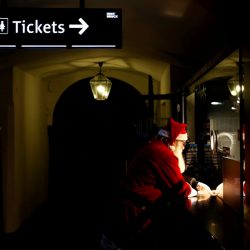 A man dressed as Santa Claus buys a ticket at the Christmas market in Innsbruck